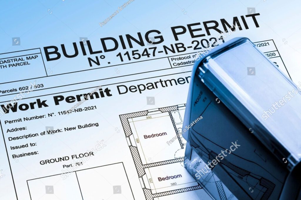 A building permit form labeled “11547-NB-2021” with architectural drawings and a blue ink stamp on top.